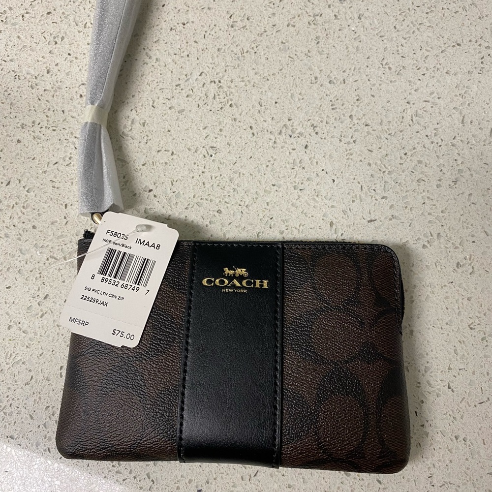 New NWT Coach Wristlet Corner Zip. Factory wrapped. Signature canvas.